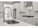 The kitchen is complete with an industrial faucet, white cabinets, and stainless steel appliances at 1723 Juniper Berry Way, Loganville, GA 30052
