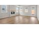 Bright living room features a modern fireplace, large windows, and an access door to the backyard at 1723 Juniper Berry Way, Loganville, GA 30052
