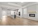 Open-concept living room view into kitchen with stainless appliances, island, and hardwood flooring at 1723 Juniper Berry Way, Loganville, GA 30052