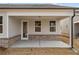 Covered patio featuring brick accents, offering a comfortable outdoor space at 1723 Juniper Berry Way, Loganville, GA 30052