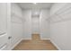 A walk-in closet featuring shelving and wood-look floors at 1723 Juniper Berry Way, Loganville, GA 30052