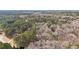 Expansive aerial view of the acreage with a well-maintained home surrounded by dense trees at 2999 Happy Hollow Dr, Conyers, GA 30094