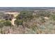 Aerial view of the extensive wooded property with a home and a clearing in the distance at 2999 Happy Hollow Dr, Conyers, GA 30094
