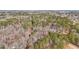 Aerial view showcasing the home's location within a large, tree-filled property at 2999 Happy Hollow Dr, Conyers, GA 30094