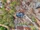 Bird's eye view of the house nestled among mature trees, showcasing the surrounding greenery at 2999 Happy Hollow Dr, Conyers, GA 30094