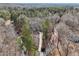 Breathtaking aerial view of a secluded home nestled within a lush forest, offering ultimate privacy at 2999 Happy Hollow Dr, Conyers, GA 30094