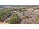 Scenic aerial view of a sprawling wooded landscape featuring a home with a long driveway, promising seclusion at 2999 Happy Hollow Dr, Conyers, GA 30094