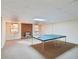 Finished basement with a ping pong table, brick fireplace, and bright lighting, perfect for entertainment at 2999 Happy Hollow Dr, Conyers, GA 30094
