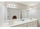Bathroom features a large mirror above a double sink vanity with wallpapered walls at 2999 Happy Hollow Dr, Conyers, GA 30094