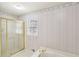 Full bathroom with a glass shower door, soaking tub, and vintage wallpaper at 2999 Happy Hollow Dr, Conyers, GA 30094
