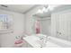 Bright bathroom with vanity, large mirror, and combination tub shower at 2999 Happy Hollow Dr, Conyers, GA 30094