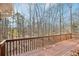 Wooden deck with brown railings, overlooking a serene wooded area at 2999 Happy Hollow Dr, Conyers, GA 30094