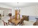 Cozy dining room featuring a wooden table, chairs, and a view into other living spaces at 2999 Happy Hollow Dr, Conyers, GA 30094