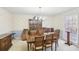 Formal dining room with a large table, decorative wallpaper, and a chandelier at 2999 Happy Hollow Dr, Conyers, GA 30094