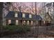 Charming brick home featuring dormer windows and a covered front porch, set against a tranquil sunset backdrop at 2999 Happy Hollow Dr, Conyers, GA 30094