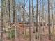 Inviting front exterior showcases classic architecture with cozy porch framed by mature trees and natural landscape at 2999 Happy Hollow Dr, Conyers, GA 30094