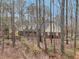 Charming front exterior with inviting porch, framed by mature trees providing privacy and a tranquil setting at 2999 Happy Hollow Dr, Conyers, GA 30094