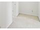 Bright hallway with neutral carpeting, leading to other rooms in the home at 2999 Happy Hollow Dr, Conyers, GA 30094