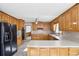 Bright kitchen features wood cabinets, black appliances, and plenty of counter space at 2999 Happy Hollow Dr, Conyers, GA 30094