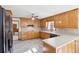 Well-lit kitchen with wooden cabinets, updated countertop, black appliances, and a ceiling fan at 2999 Happy Hollow Dr, Conyers, GA 30094