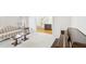 Cozy living room area with neutral carpet, with an open doorway to hardwood staircase at 2999 Happy Hollow Dr, Conyers, GA 30094