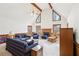 Bright living room boasts vaulted ceilings, exposed beams, and a charming brick fireplace at 2999 Happy Hollow Dr, Conyers, GA 30094