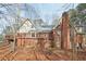 Stunning rear exterior with spacious wooden deck and beautiful brickwork, offering both comfort and visual appeal at 2999 Happy Hollow Dr, Conyers, GA 30094