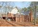 Charming rear exterior featuring an expansive wooden deck perfect for outdoor entertaining and relaxing at 2999 Happy Hollow Dr, Conyers, GA 30094