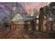 Back view of the brick home featuring a spacious deck, a walkout basement and a chimney at 2999 Happy Hollow Dr, Conyers, GA 30094