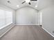 Bright bedroom featuring neutral carpet, vaulted ceiling with fan, and a large window at 3194 Haynes Park Dr, Lithonia, GA 30038