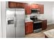 Well-equipped kitchen with stainless steel appliances and wood cabinets at 3194 Haynes Park Dr, Lithonia, GA 30038