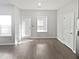 Light-filled living room featuring door, window, and vinyl wood flooring at 3194 Haynes Park Dr, Lithonia, GA 30038