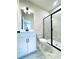 Modern bathroom featuring a glass-enclosed shower, marble floors, and sleek white vanity at 718 Crossroad Ct, Powder Springs, GA 30127