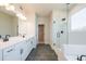 Modern bathroom with double sinks, a frameless shower, and dark tile floors at 718 Crossroad Ct, Powder Springs, GA 30127