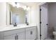 Bathroom featuring double vanity with modern fixtures and an open doorway at 718 Crossroad Ct, Powder Springs, GA 30127