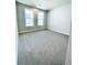 Bright, carpeted bedroom with two large windows offers plenty of natural light at 718 Crossroad Ct, Powder Springs, GA 30127