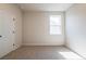 Comfortable bedroom with carpeting, a window for natural light, and a closet at 718 Crossroad Ct, Powder Springs, GA 30127