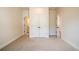 Neutral bedroom featuring closet space and doorways leading to ensuite bath and hall at 718 Crossroad Ct, Powder Springs, GA 30127