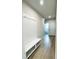 Hallway featuring a convenient hall tree with hooks and seating, plus wood-look flooring at 718 Crossroad Ct, Powder Springs, GA 30127