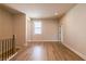 A hallway with light colored walls, wood floors, a window, and access to other rooms at 718 Crossroad Ct, Powder Springs, GA 30127