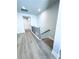 Hallway with beautiful gray wood flooring and a staircase with black metal balusters at 718 Crossroad Ct, Powder Springs, GA 30127