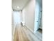 Hallway with wood-look floors, convenient coat rack with seating, and nearby closet at 718 Crossroad Ct, Powder Springs, GA 30127