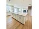 Modern kitchen features a large island with white cabinets and beautiful countertops at 718 Crossroad Ct, Powder Springs, GA 30127