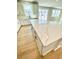 View of a kitchen featuring an island with white quartz countertops and light hardwood floors at 718 Crossroad Ct, Powder Springs, GA 30127