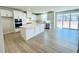 Open concept kitchen featuring stainless appliances, white cabinets, and large island with doors to the backyard at 718 Crossroad Ct, Powder Springs, GA 30127
