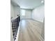 Open loft area with durable floors and view to staircase is a flexible space at 718 Crossroad Ct, Powder Springs, GA 30127