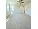 A bright main bedroom with a ceiling fan and two windows at 718 Crossroad Ct, Powder Springs, GA 30127