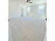 Spacious main bedroom featuring plush carpet, ceiling fan, and natural light from the windows at 718 Crossroad Ct, Powder Springs, GA 30127