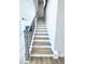Staircase with wooden treads and white risers leads to the home's upper level at 718 Crossroad Ct, Powder Springs, GA 30127