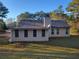 A back exterior view of a well-maintained home with vinyl siding and a nice lawn at 104 Worthy Drive, Mcdonough, GA 30252